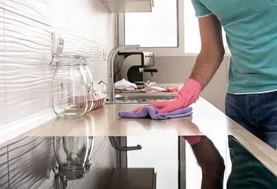 Cleaning professional using a microfiber cloth on a bright, spotless home surface